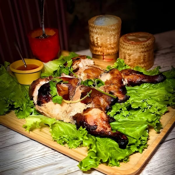 Zaab Zaab's whole roasted chicken, cut into pieces, served on lettuce with dipping sauce.
