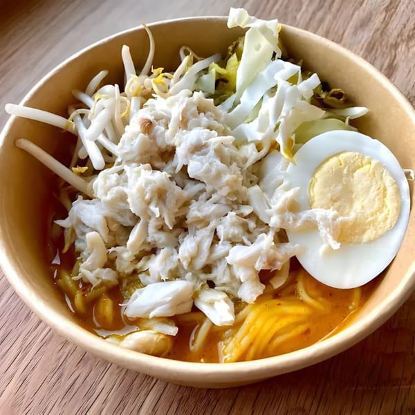 Zaab Zaab's Thai dish with noodles, crab meat, bean sprouts, cabbage, and a hard-boiled egg.