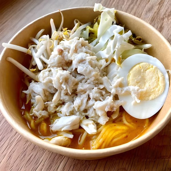 Zaab Zaab's Thai curry noodles with crab meat, bean sprouts, cabbage, and a hard-boiled egg.
